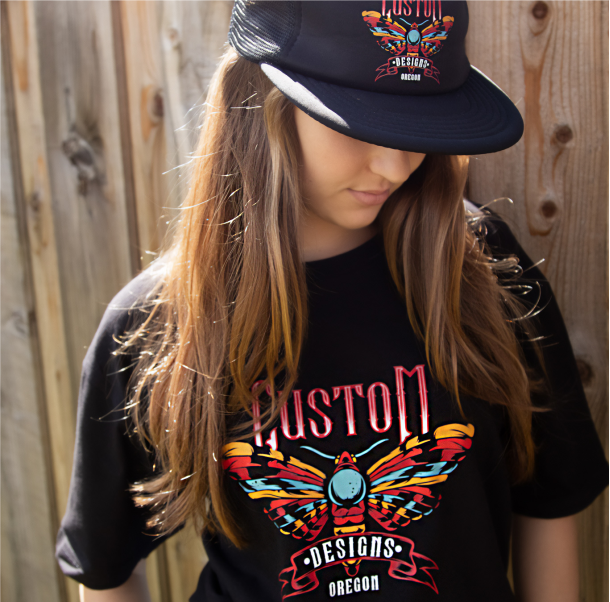 Picture of a girl with DTF transfers on her black hat and black t-shirt 