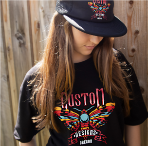 Picture of a girl with DTF transfers on her black hat and black t-shirt 